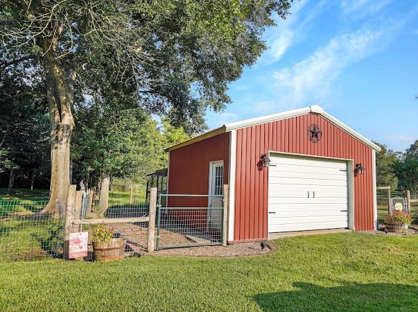 garage featuring a lawn