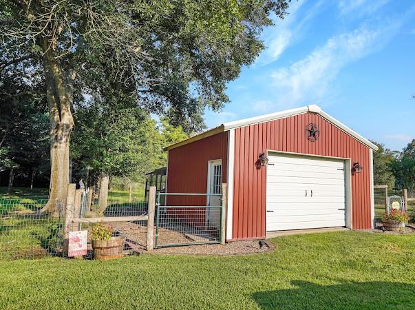 view of outbuilding with a garage and a yard