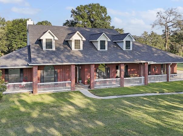 cape cod-style house with a front yard