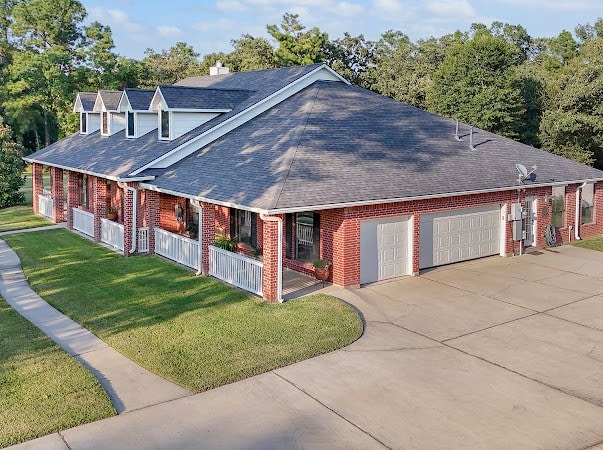 view of side of home featuring a lawn and a garage