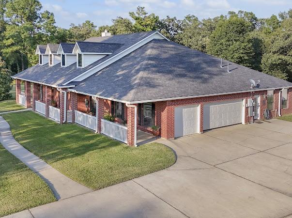 exterior space with a garage and a lawn