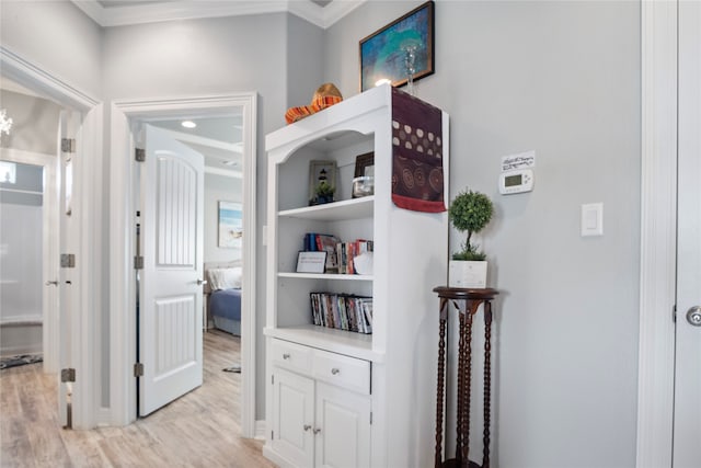 corridor featuring light hardwood / wood-style floors and ornamental molding