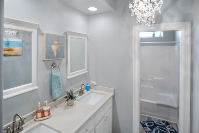 bathroom with an inviting chandelier, shower / tub combination, and vanity