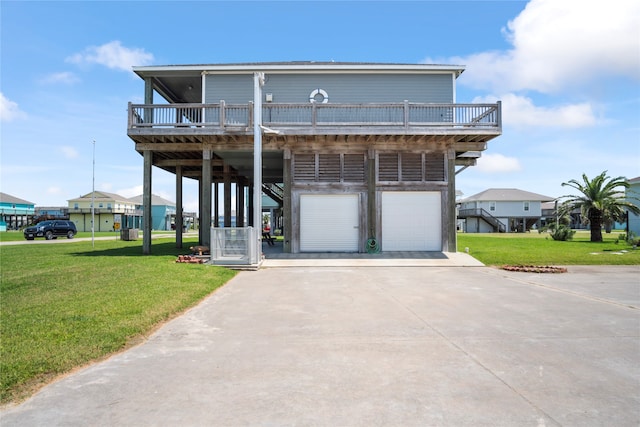 view of front of property with a balcony, a front yard, a garage, and a carport