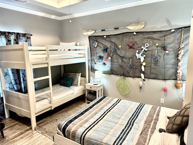 bedroom featuring hardwood / wood-style flooring and ornamental molding