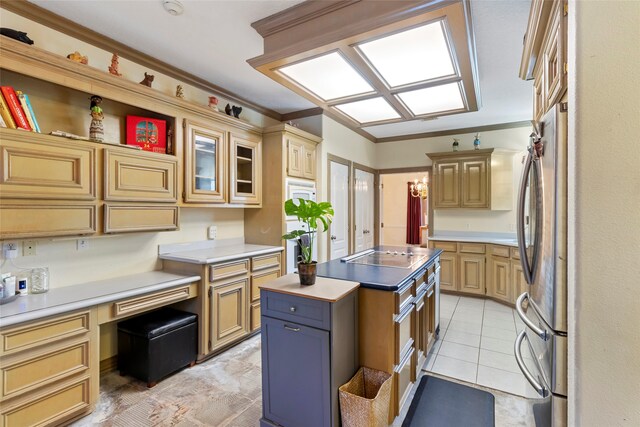 kitchen with light brown cabinets, stainless steel fridge, light tile patterned floors, a center island, and black electric cooktop