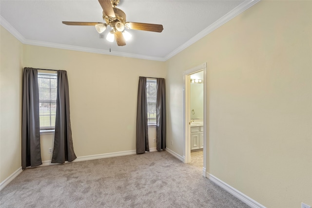 carpeted spare room featuring ornamental molding and ceiling fan