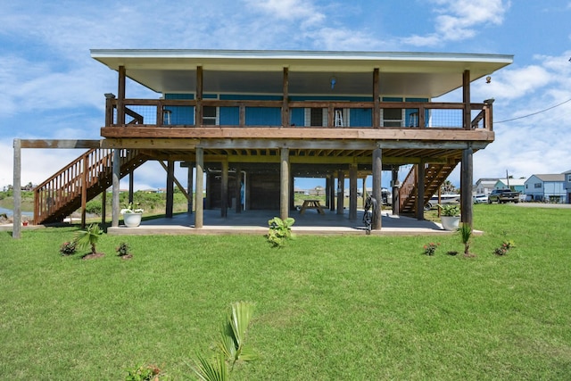 back of house with a patio area and a yard