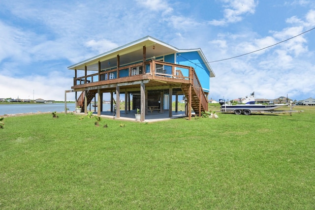 back of house with a lawn and a water view