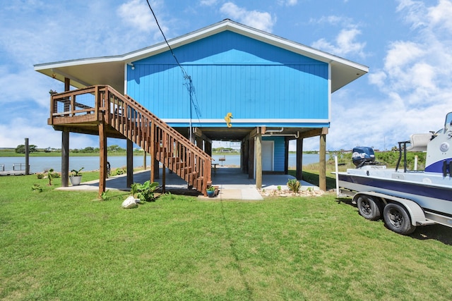 exterior space with a lawn and a deck with water view