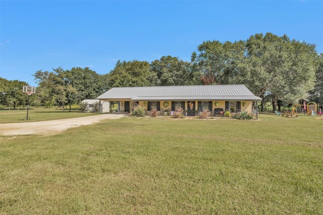 ranch-style house with a playground and a front yard