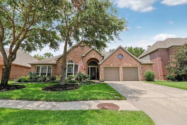 view of front of house featuring a garage and a front lawn