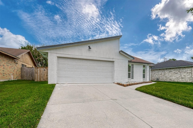 view of front of house featuring a front yard and a garage