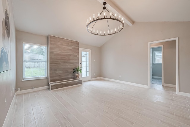 interior space with a notable chandelier and vaulted ceiling with beams