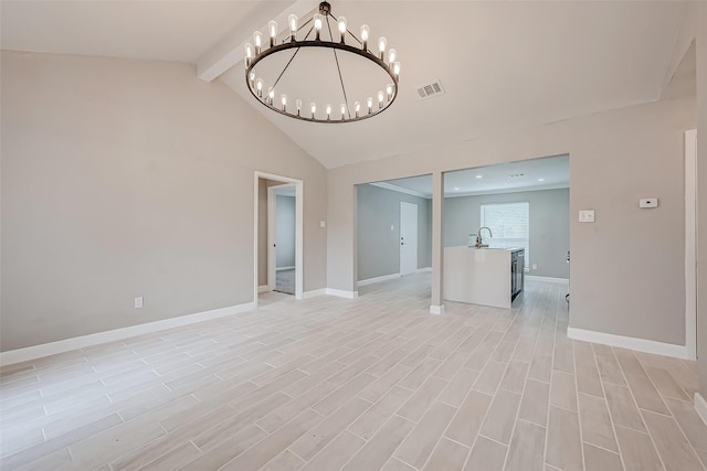 spare room featuring sink, a chandelier, and lofted ceiling with beams