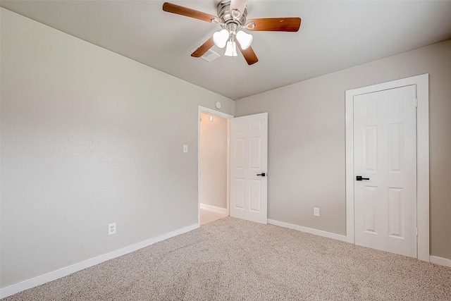 carpeted spare room featuring ceiling fan