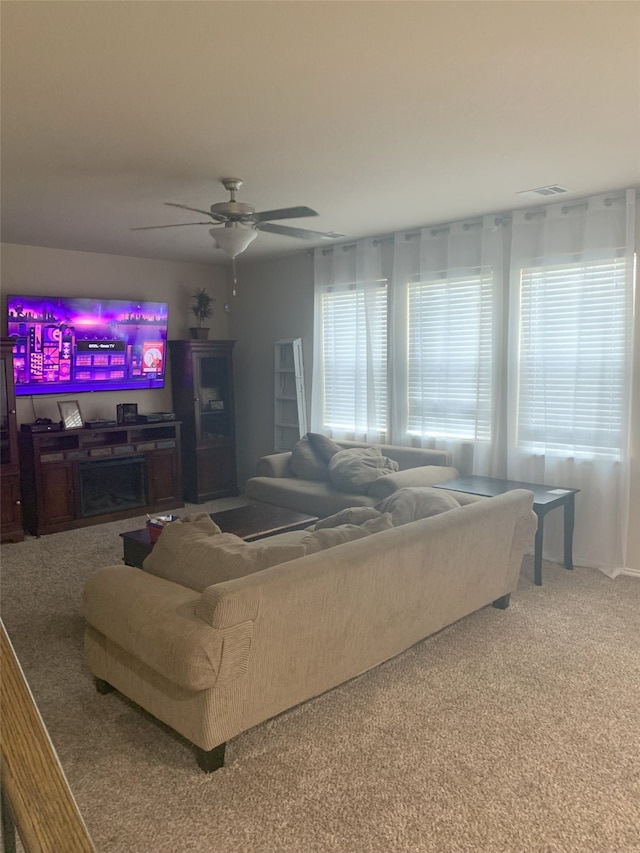 living room with carpet flooring, ceiling fan, and a wealth of natural light