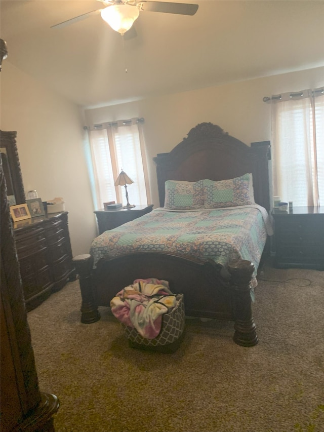 bedroom with carpet flooring, multiple windows, ceiling fan, and lofted ceiling