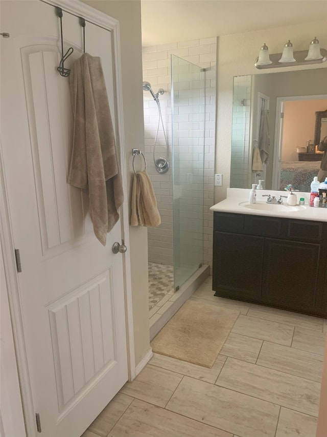 bathroom with walk in shower and vanity