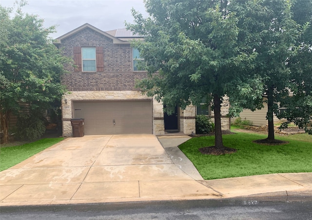 view of front of home featuring a garage and a front yard