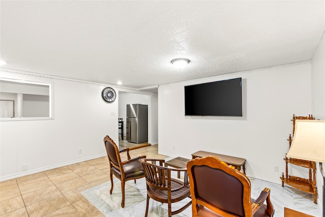 dining area featuring light tile patterned flooring and a textured ceiling