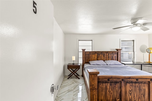 bedroom featuring ceiling fan, a textured ceiling, multiple windows, and light tile patterned floors