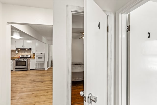 hallway with light hardwood / wood-style floors