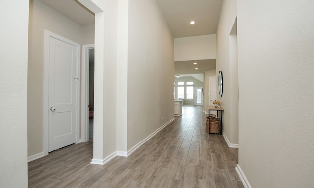 corridor with light hardwood / wood-style floors