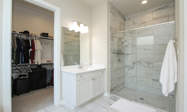 bathroom featuring tile patterned floors, vanity, and a shower with door