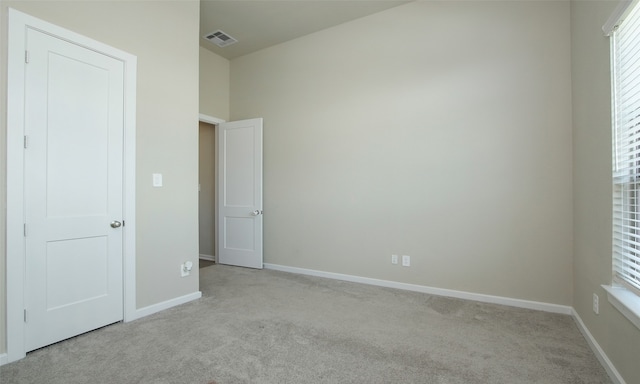 unfurnished bedroom with light colored carpet