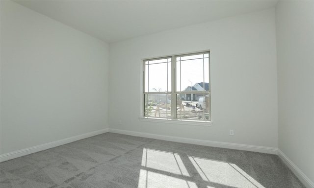 spare room featuring light carpet