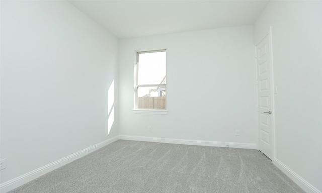 spare room featuring light colored carpet