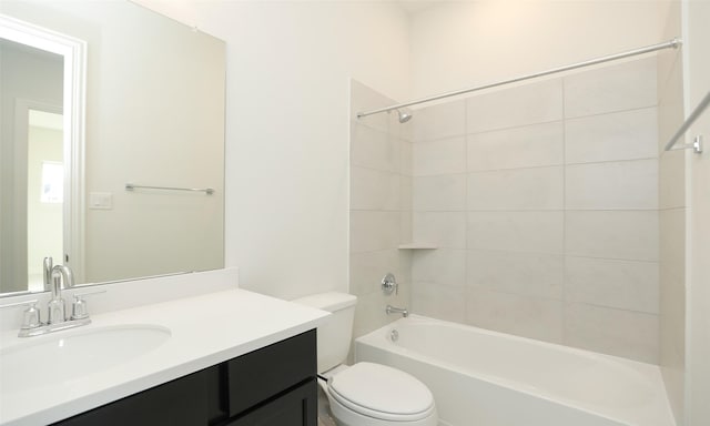 full bathroom with vanity, tiled shower / bath, and toilet