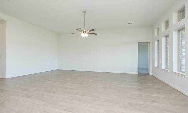 empty room featuring ceiling fan and light hardwood / wood-style flooring