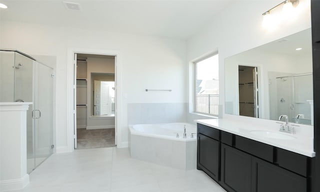 bathroom featuring tile patterned flooring, vanity, and plus walk in shower