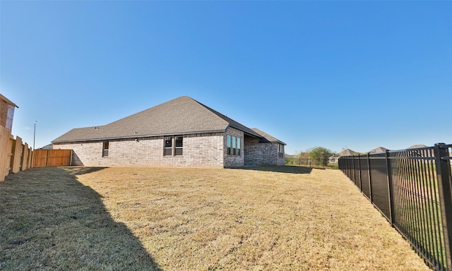 rear view of property with a yard