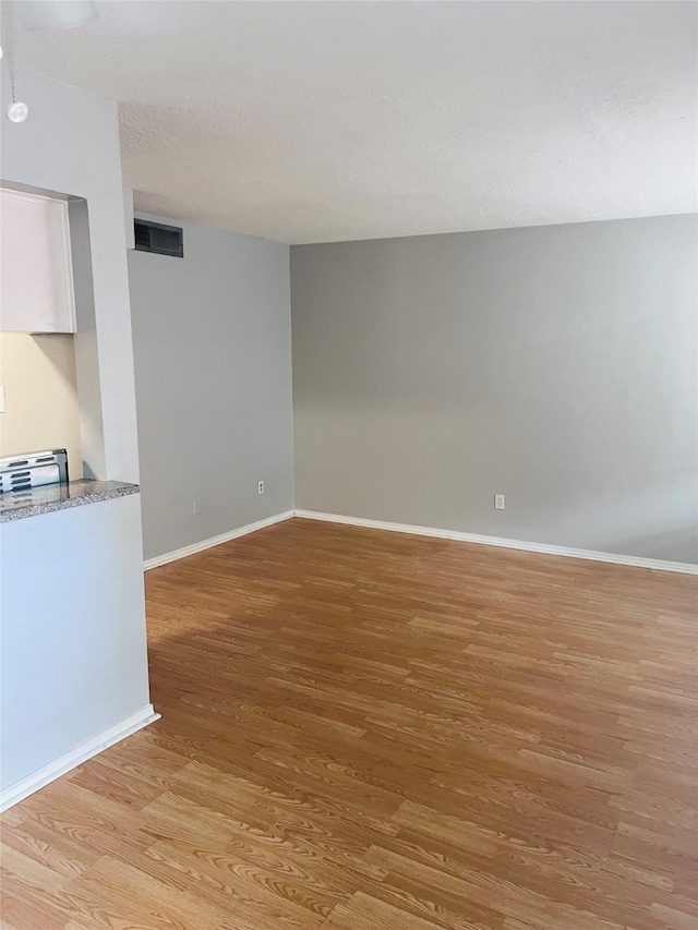 empty room with light hardwood / wood-style floors