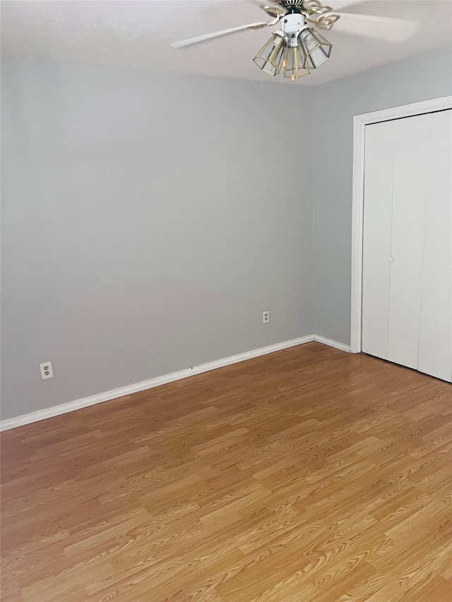 spare room featuring light hardwood / wood-style flooring and ceiling fan