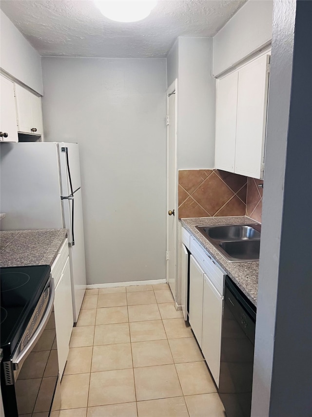 kitchen featuring dishwasher, backsplash, sink, light tile patterned floors, and white cabinets