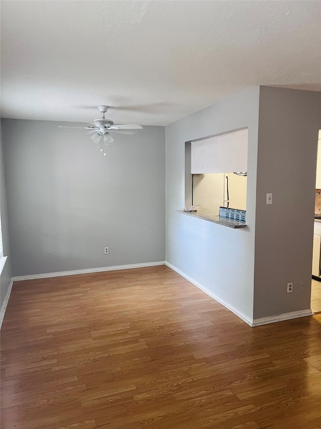 unfurnished room featuring ceiling fan and hardwood / wood-style flooring