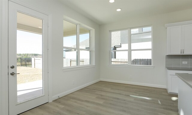 unfurnished dining area with light hardwood / wood-style flooring