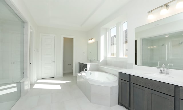 bathroom featuring tile patterned flooring, vanity, and shower with separate bathtub