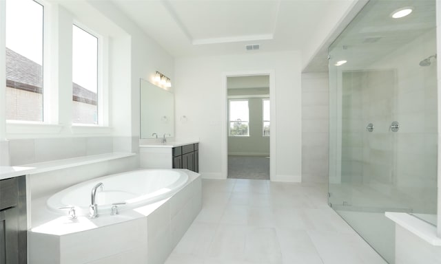 bathroom featuring separate shower and tub, a tray ceiling, vanity, and tile patterned flooring