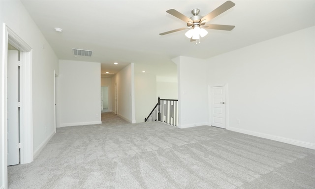 carpeted spare room featuring ceiling fan