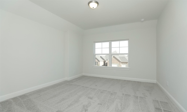 unfurnished room featuring light colored carpet