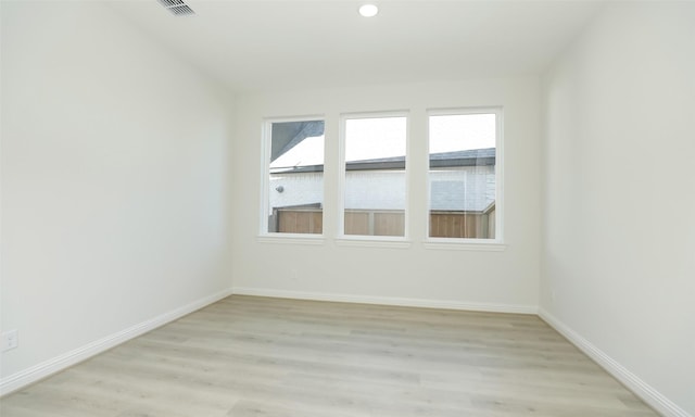 empty room with light hardwood / wood-style flooring