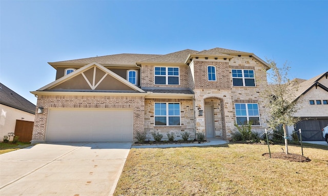 view of front of property with a front yard and a garage