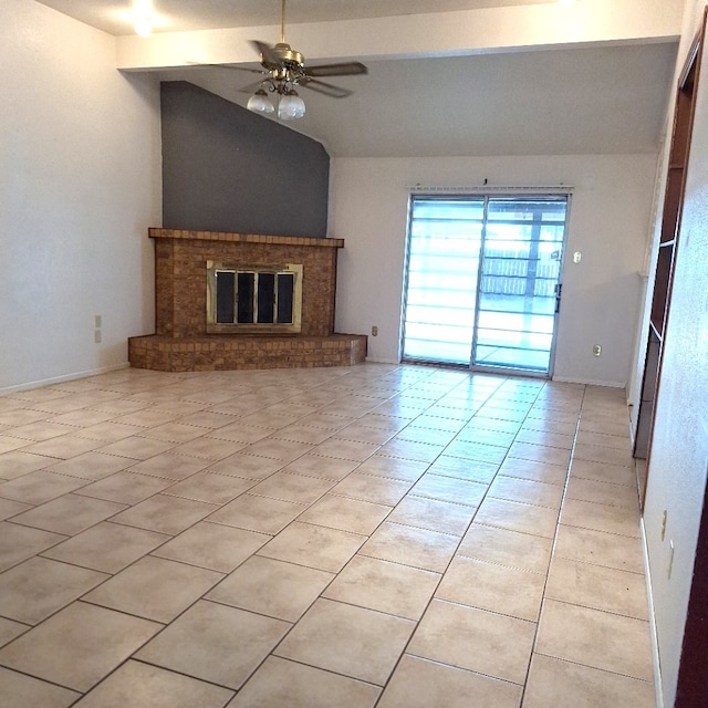 unfurnished living room with a fireplace, lofted ceiling, light tile patterned floors, and ceiling fan