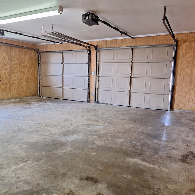 garage featuring wooden walls and a garage door opener