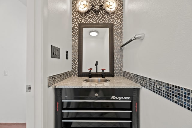 bathroom with vanity and tile walls